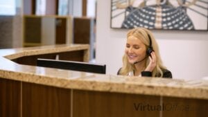 A Servcorp receptionist smiling and answering calls.