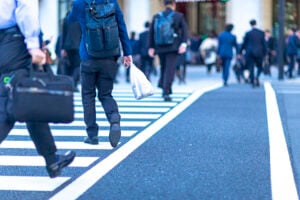 Employees walking back to work as companies support the return to office movement.