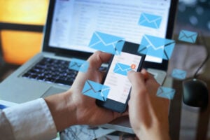 A businessman checking his emails via a smartphone.