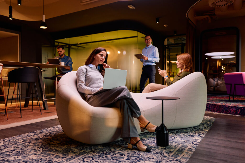 A Modern coworking lounge with two professional women working.
